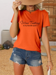 Close-up of orange cotton t-shirt with Wine Tasting text print and denim shorts