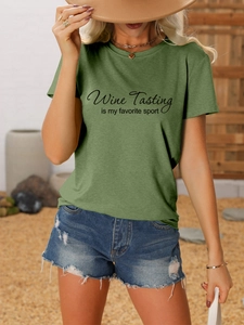 Detail of olive green t-shirt with Wine Tasting text print and distressed denim shorts