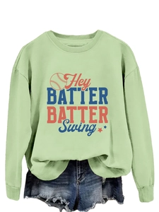 Détail d'un sweat-shirt de baseball vert clair avec texte rétro et motif baseball