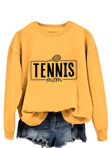 Detail of yellow sweatshirt with Tennis Mom print and denim shorts for casual look