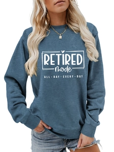 Close-up of Retired Mode print on blue-grey sweatshirt with ribbed crew neck detail