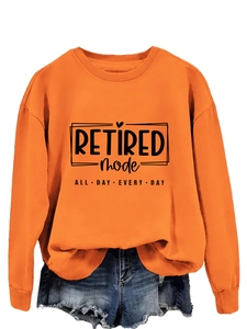 Detail of orange sweatshirt with Retired Mode print and ribbed crew neckline texture