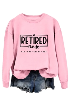 Detail of pink crewneck sweatshirt with black Retired Mode All Day Every Day slogan print