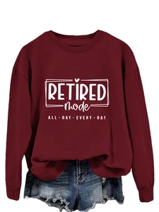 Close-up of Retired Mode text and heart icon print on wine red crewneck sweatshirt