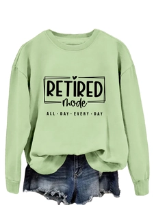 Detail of light green sweatshirt with Retired Mode text print and casual round neck