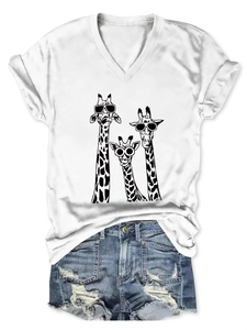 Detail of white V-neck T-shirt featuring three giraffes with sunglasses and denim shorts