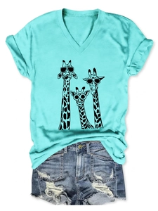Detail of teal V-neck T-shirt showing three giraffe prints and rolled short sleeves