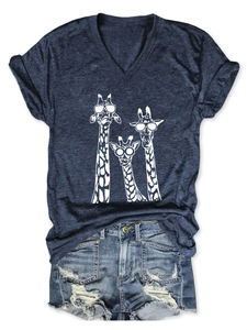 Detail of navy V-neck T-shirt with white giraffe print and worn denim shorts