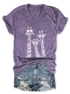 Detail of purple V-neck giraffe t-shirt with ripped denim shorts on white background