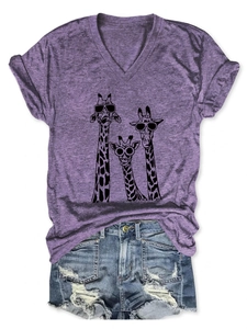 Flat lay of purple V-neck T-shirt with three giraffes and distressed denim shorts