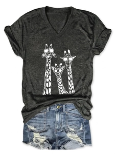 Flat lay of women's dark gray V-neck T-shirt with three giraffes and denim shorts