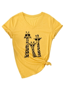 Detail of yellow V-neck T-shirt with giraffe print, rolled sleeves and knotted hem design