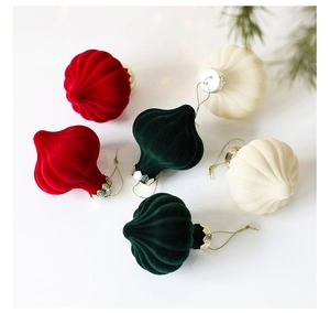 Detail of onion-shaped flocked Christmas balls in red, green and white with gold caps
