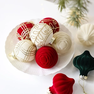 Christmas tree ornaments set with red, white, and green flocked balls in a ceramic dish