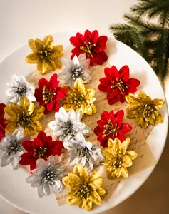 Detail of red and gold poinsettia flowers on vintage paper for Christmas tree decor