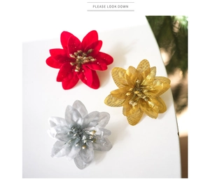 Detailed view of red, gold, and silver 6cm poinsettia flowers for Christmas tree decoration