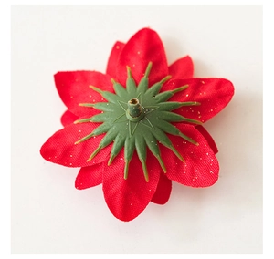 Detailed back view of red velvet Christmas flower with golden sequins and plastic base