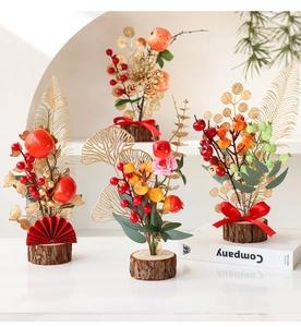 Macro detail of Chinese New Year red berry bonsai with golden leaves on wooden base