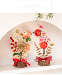 Detail of Chinese New Year table decor with persimmons, coins and festive ribbons