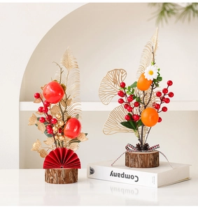 Detail of New Year red berry ornaments with persimmons, gold leaves and wooden bases