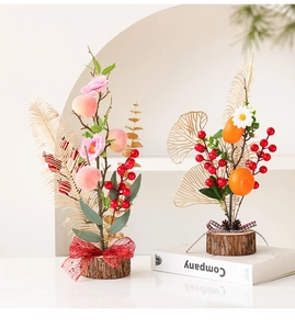 Close-up of Chinese New Year red berry ornaments with wooden base and golden leaf details