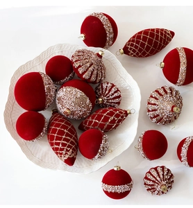 Macro shot of red flocked Christmas ornaments with pearls and gold glitter details