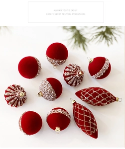 Close-up of red flocked Christmas ornaments with pearl beads and golden glitter details