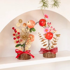 New Year tabletop decoration featuring red berries, golden leaves, and natural wooden base