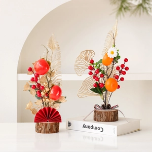 Chinese New Year desktop decor featuring red berries and festive persimmon ornaments