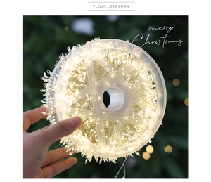 Detail of warm white high-density LED firecracker lights wrapped on a star-shaped spool