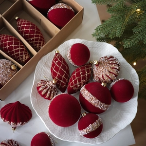 Luxury red flocked Christmas ornaments set with gold embroidery and pearls on tree