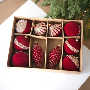 10-piece set of red flocked Christmas ornaments with gold glitter in a kraft gift box