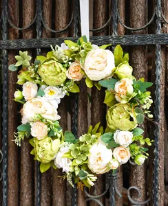 Dettaglio di ghirlanda di peonie crema e ortensie su una recinzione in legno