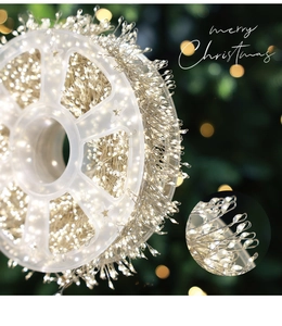 Macro detail of warm white LED firecracker fairy lights on wire for Christmas decor