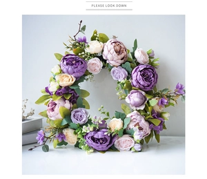 Detailed close-up of vibrant artificial peony wreath with mixed purple and cream flowers