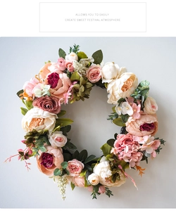 Detail view of pink peony and rose wreath with realistic petal textures and soft green leaves