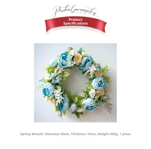 Detail view of blue and cream artificial peonies with green leaves on a spring wreath