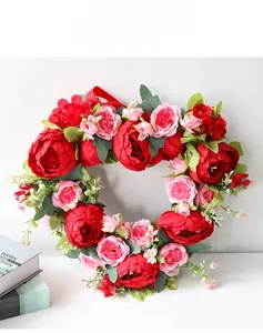 Macro detail of heart-shaped artificial peony wreath with red and pink silk flowers