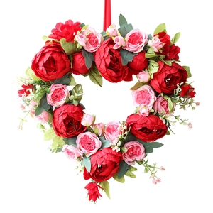 Heart-shaped wreath with red peonies and pink roses for wedding or home wall decoration