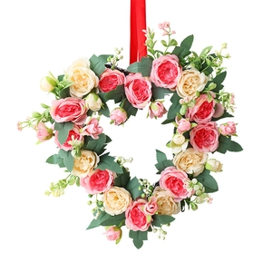 Pink and beige heart-shaped rose wreath with green leaves and silk ribbon for wall hanging