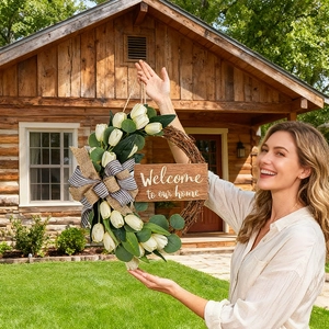Detail of tulip wreath with eucalyptus leaves and Welcome to our home wooden sign