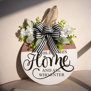Rustic round wooden wreath sign with BLESS THIS HOME text and black striped bow decoration