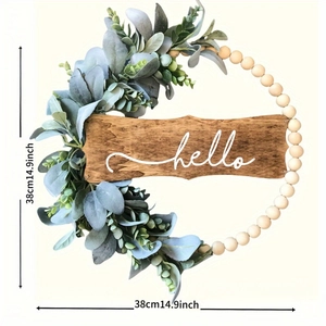 Modern eucalyptus wreath with wooden beads and a Hello sign for home wall decor