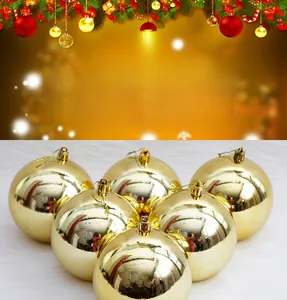 Detail view of 8cm glossy gold Christmas ornaments with strings on white faux fur