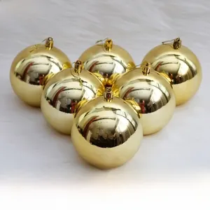 Close-up of shiny gold Christmas ornaments with mirror finish on white fur background