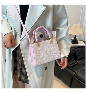 Pink embossed leather handbag with woven handles and light gold hardware detail