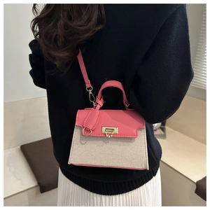 Detail of pink leather and beige canvas contrast stitching on Kelly style crossbody bag
