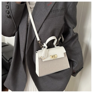 Chic Kelly bag style showing cross-body wear with white leather and beige woven patchwork