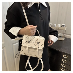 Detailed view of the white polka dot PU leather crossbody bag with a cartoon hamburger icon