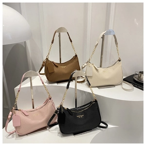 Detailed arrangement of woven texture handbags in brown, white, pink and black
